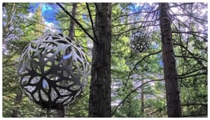Metal Spheres Hanging in the Pines